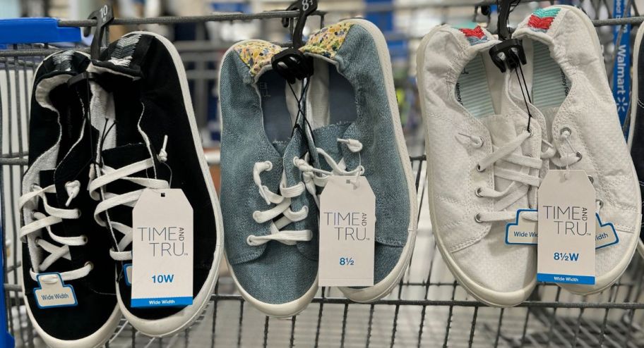 3 pair of time and true scrunch back sneakers hanging on the side of a shopping cart