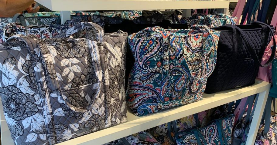 many vera bradley totes on shelf