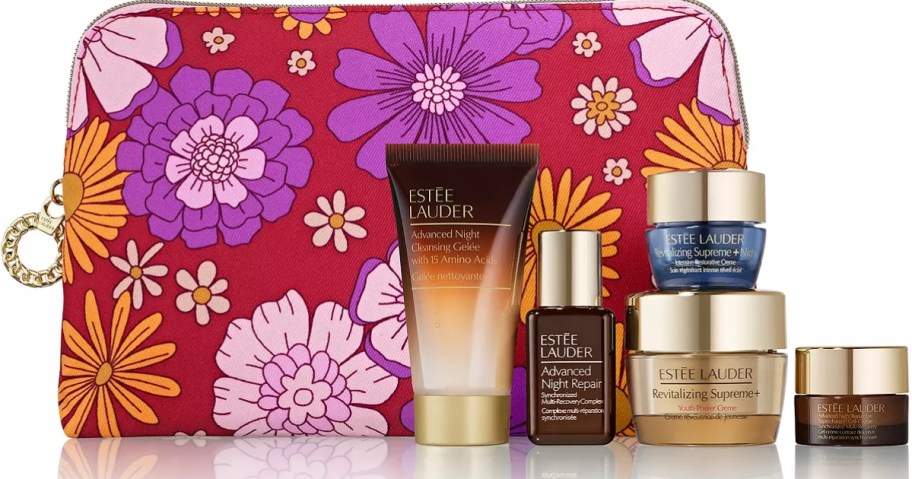 a red purple and pink floral cosmetic bag with Estee Lauder skincare items in front of it