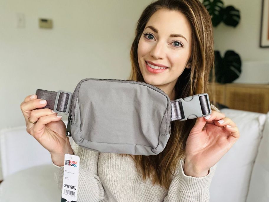 Woman holding a 32 Degrees belt bag