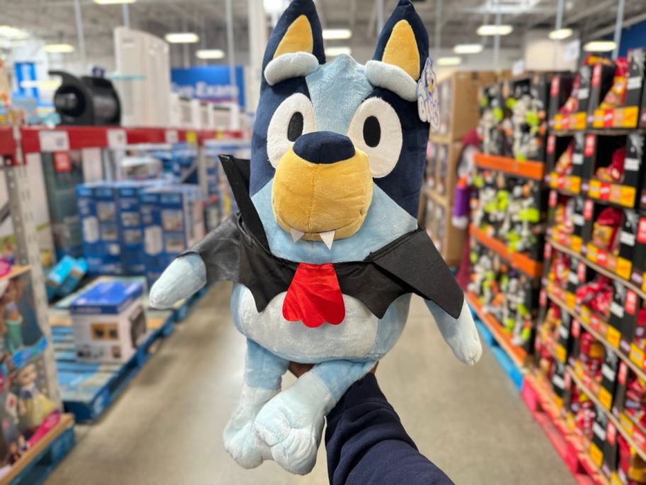 hand holding Bluey vampire 18-inch Jumbo Halloween Plush in store