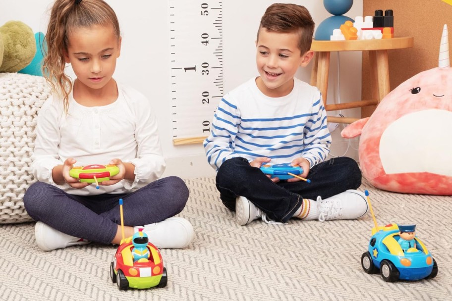 a boy and a girl playing on the carpet with Prextex Cartoon Remote Control Cars