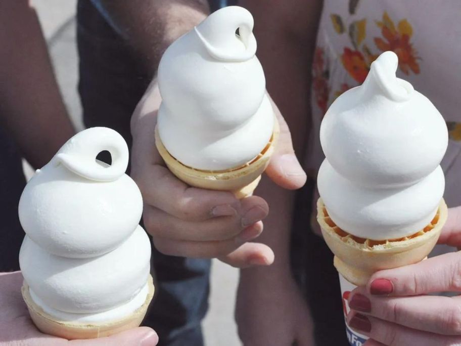 3 people holding DQ vanilla cones