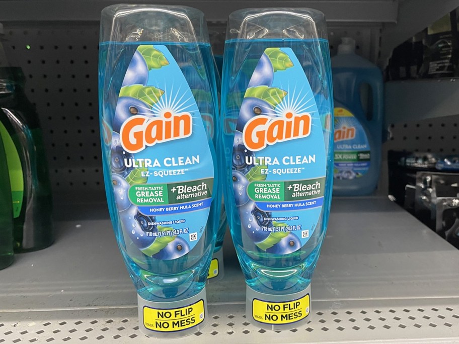 two blue bottles of Gain EZ-Squeeze Dish Soap on store shelf