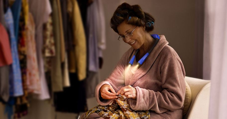 woman using a neck light to do needlework