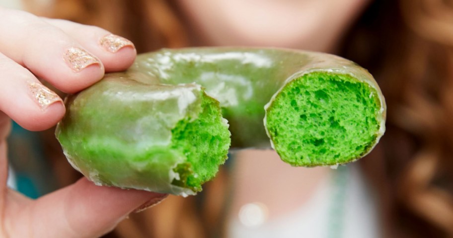 green colored glazed doughnut with bite taken out