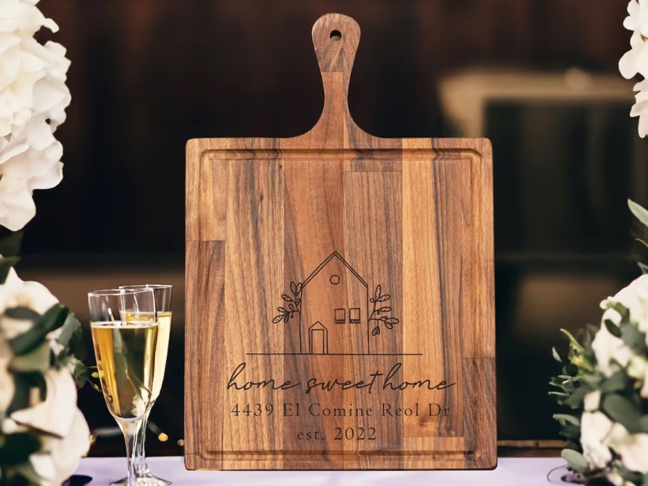 engraved cutting board that says home sweet home with home address on it