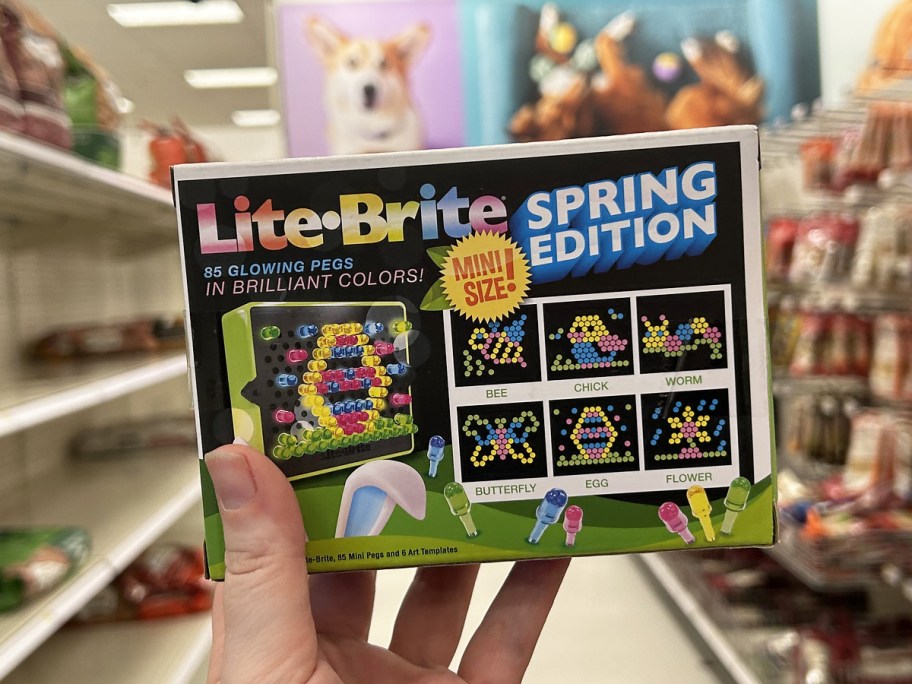 hand holding up a mini Lite Brite set in store