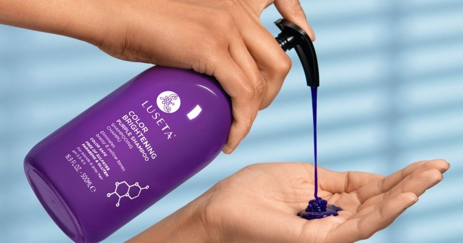 Hand pumping Luseta Purple Shampoo into the other hand