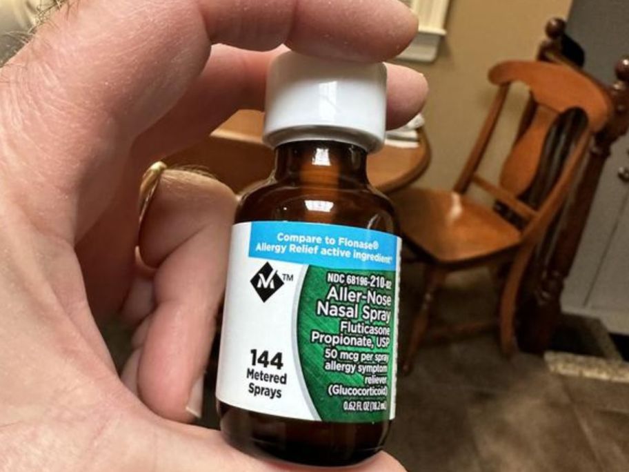 Hand holding a bottle of Member's Mark Nasal Spray