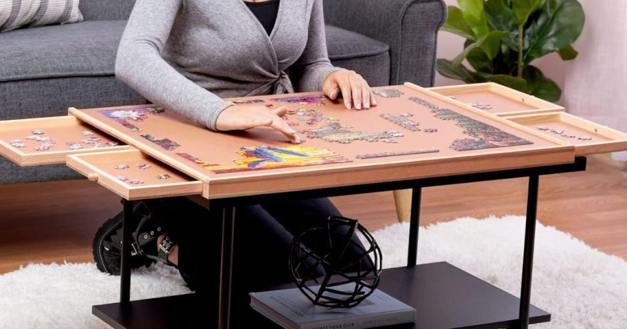 A woman with a Playvibe 1000 Piece Rotating Wooden Jigsaw Puzzle Table