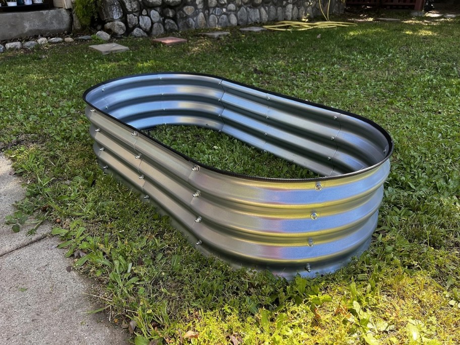 empty metal raised garden bed on grass