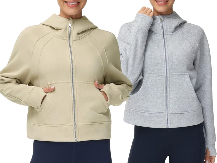 2 women wearing zip up hoodies 