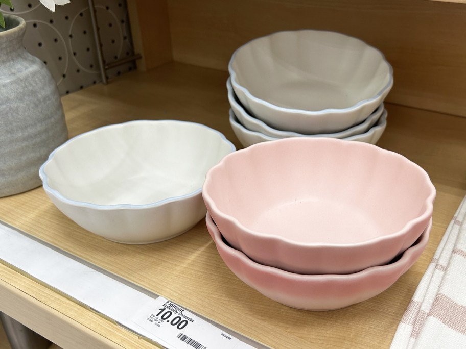 stacks of white and pink scalloped stoneware bowls