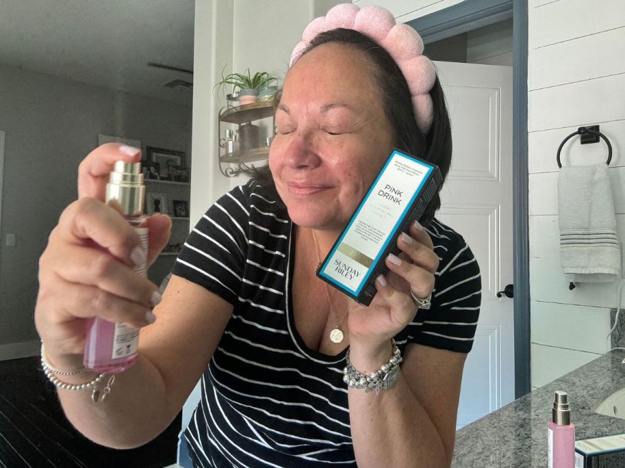 Woman spraying Sunday Riley Pink Drink on her face