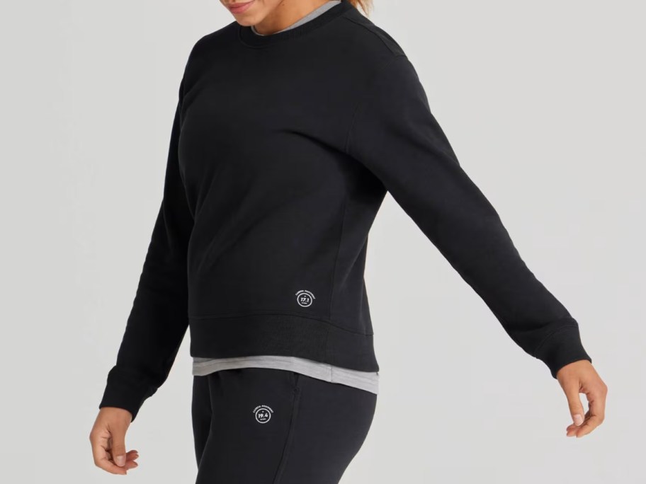 woman earing a black allbirds sweatshirt and sweatpans