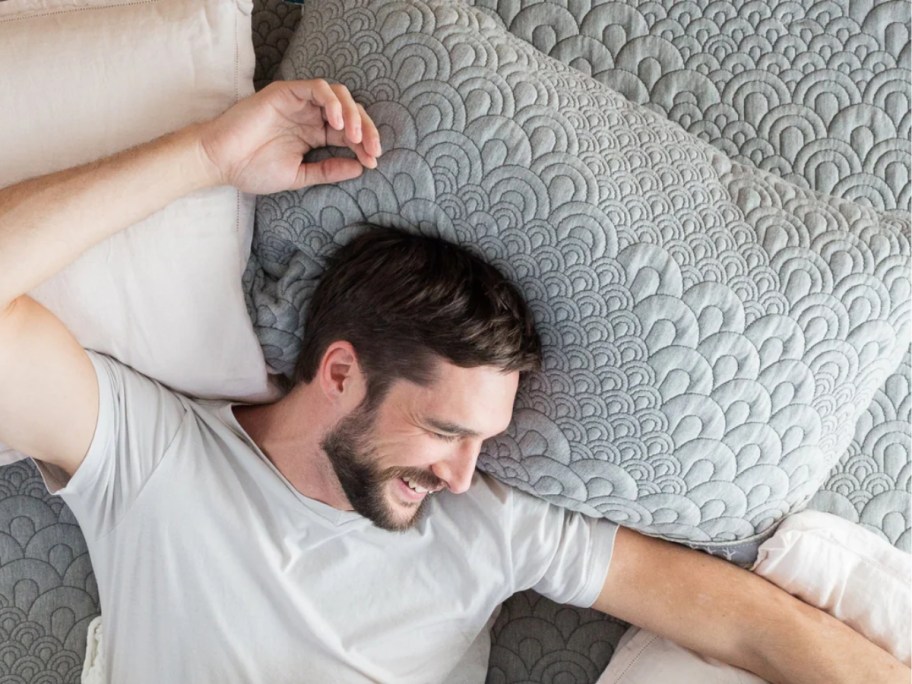 man laying on a grey pillow