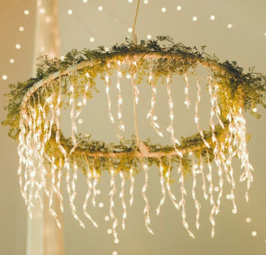 hula hoop with lights hanging down from greenery