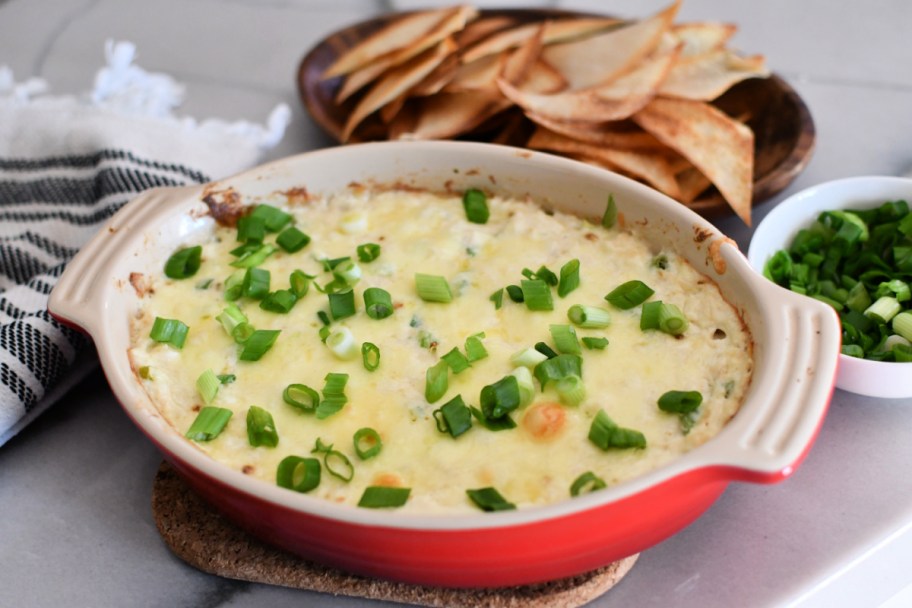 finished crab rangoon dip out of the oven next to wontons