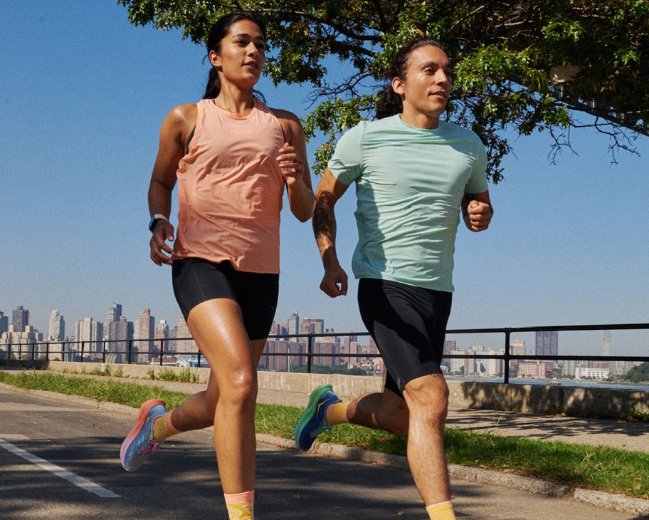 man and woman running in hoka clothes