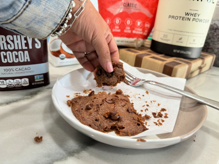 holding a piece fo chocolate cookie