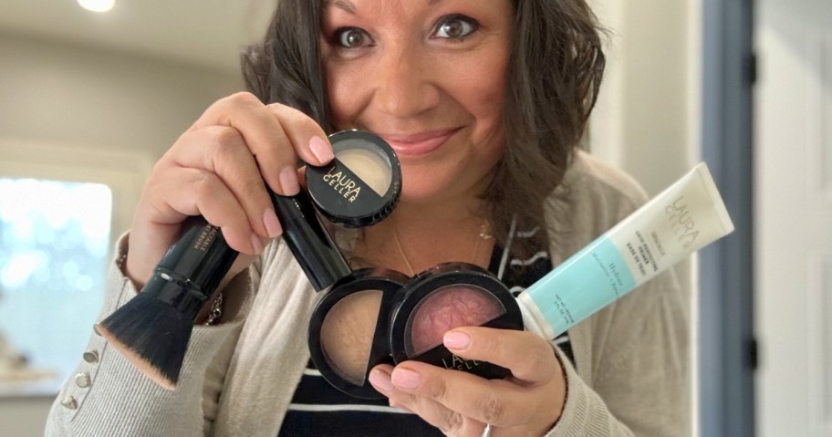 Lina holding various Laura Geller makeup items up to the camera