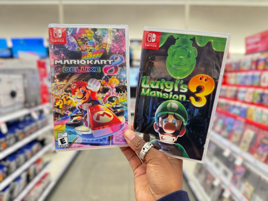 mario kart and luigi's mansion 3 nintendo switch games in hand