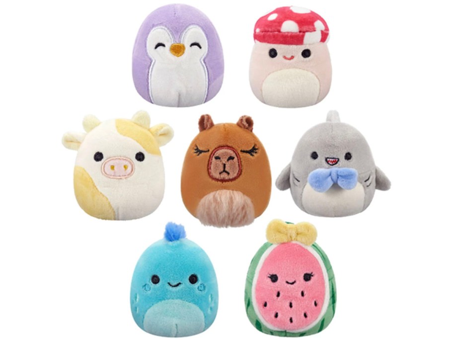 7 mini squishmallows including a penguin, mushroom, cow, shark, capybara, shark and watermelon