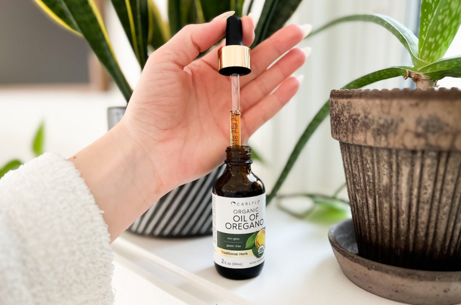 hand holding oil of oregano tincture