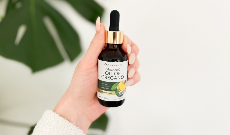 hand holding oil of oregano 