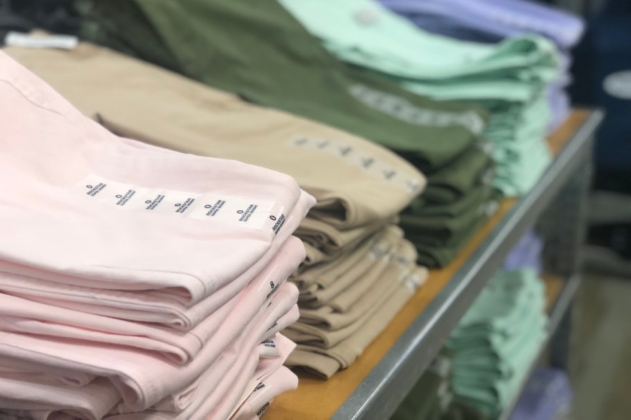 stack of womens pants folded on table