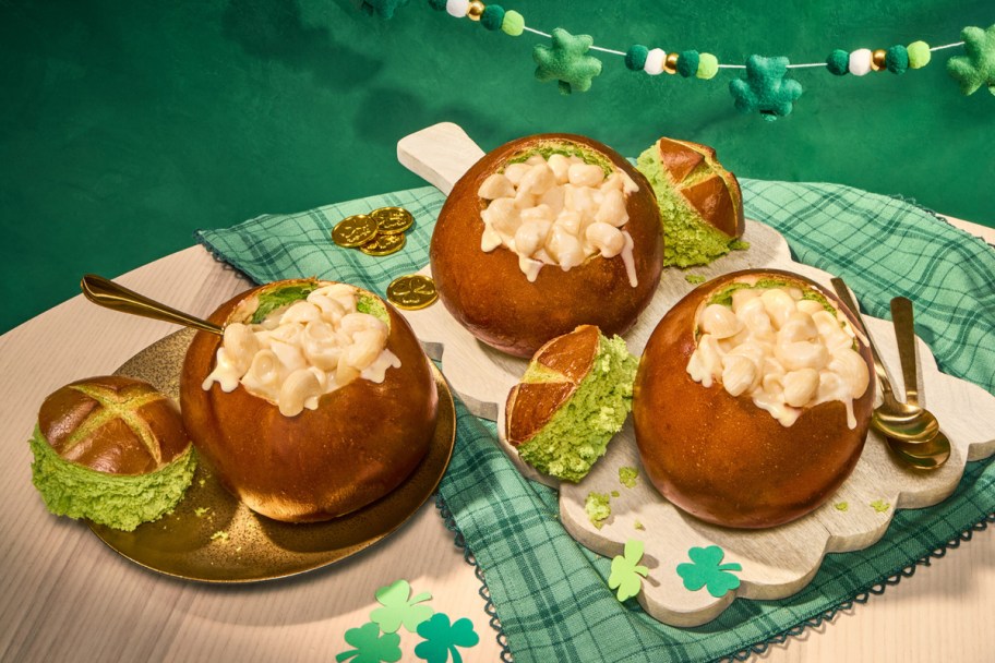 macaroni and cheese in bread bowls on a green background