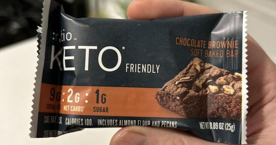 a hand holding a ratio soft baked brownie bar