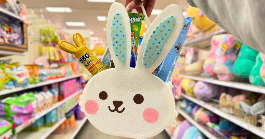 hand holding a white felt bunny shaped Easter basket in a store aisle