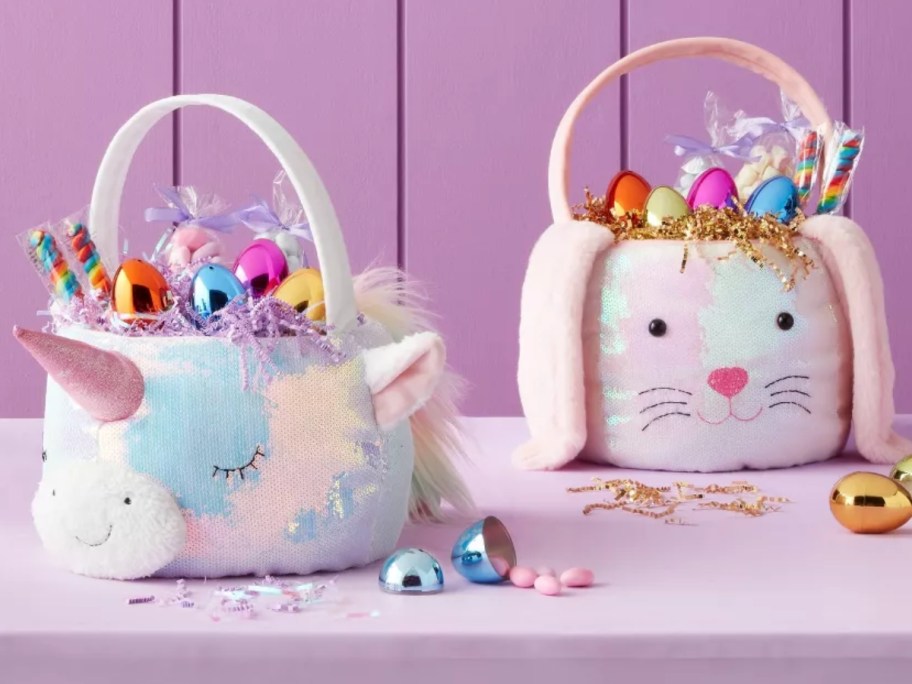 sequin plush Easter Baskets shaped like a unicorn face and bunny face with eggs and candy in them