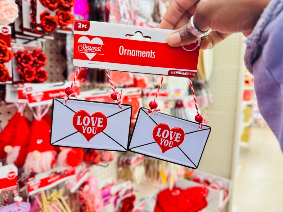 hand holding Valentine's day envelope ornaments in dollar tree