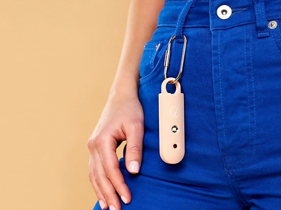 woman wearing vantamo personal alarm hanging on keychain on blue jeans