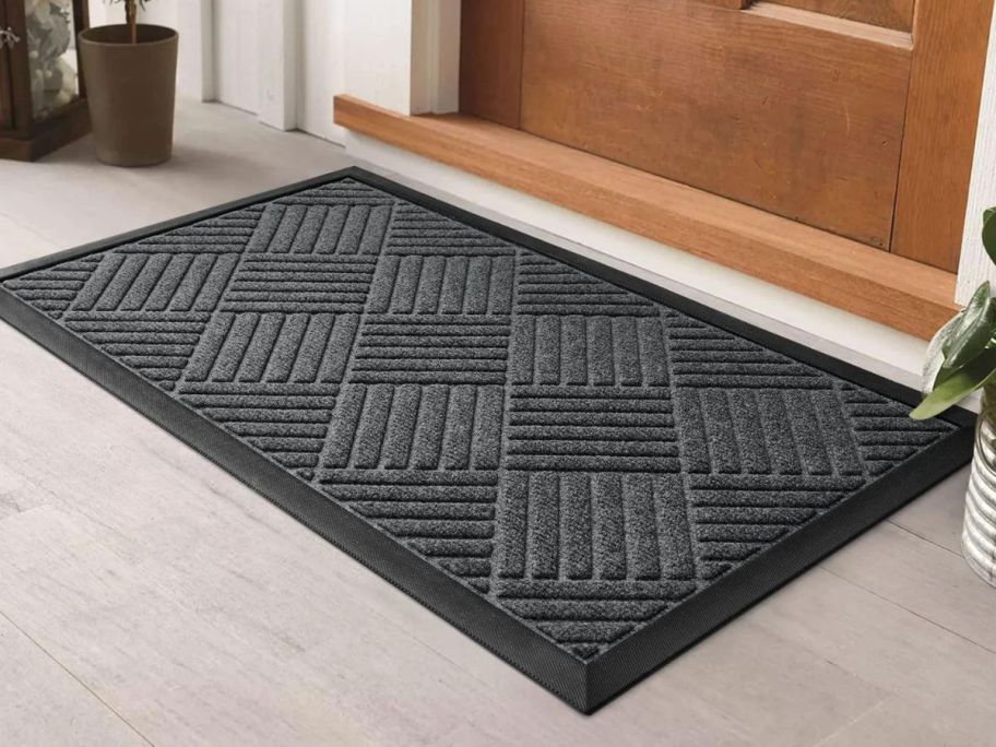 black Non-Slip Outdoor Doormat in front of brown door