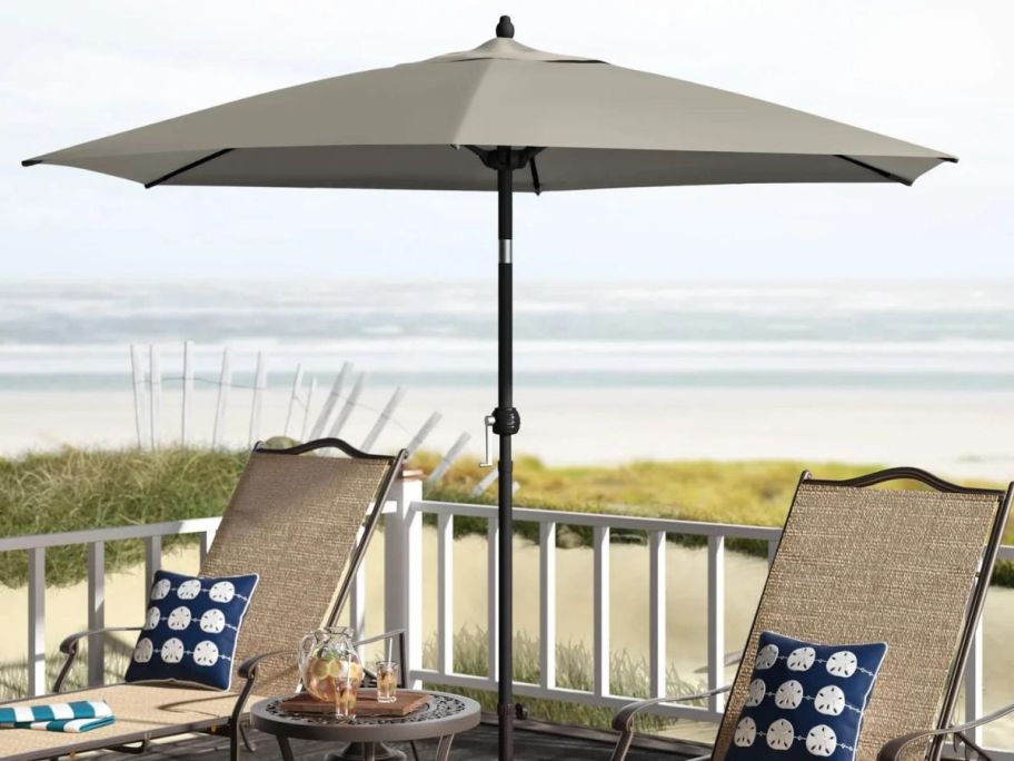 green umbrella on deck by beach