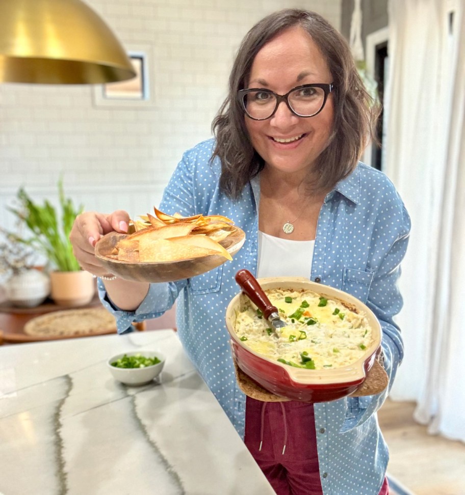 woman holding wontons and crab dip