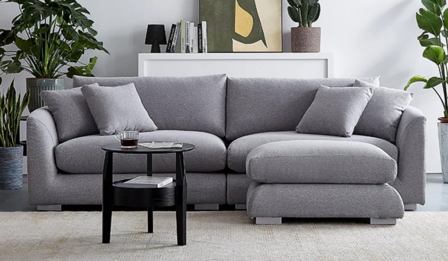 light grey loveseat and ottoman