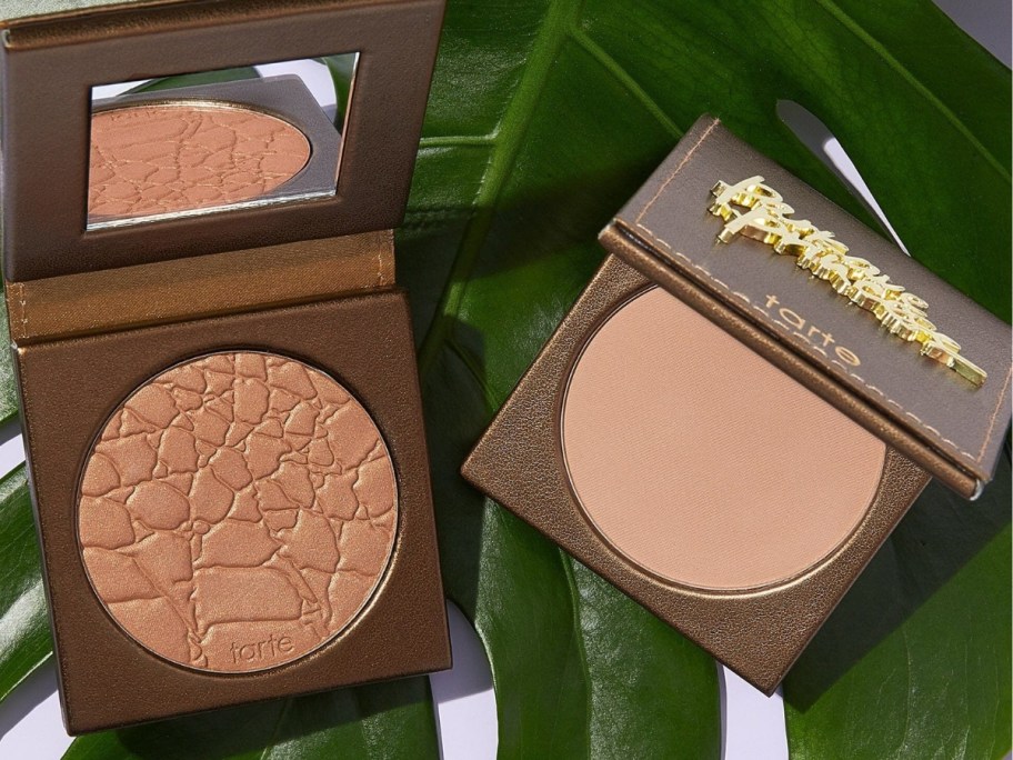 2 Tarte Amazonian Clay Waterproof Bronzers open on a palm leaf