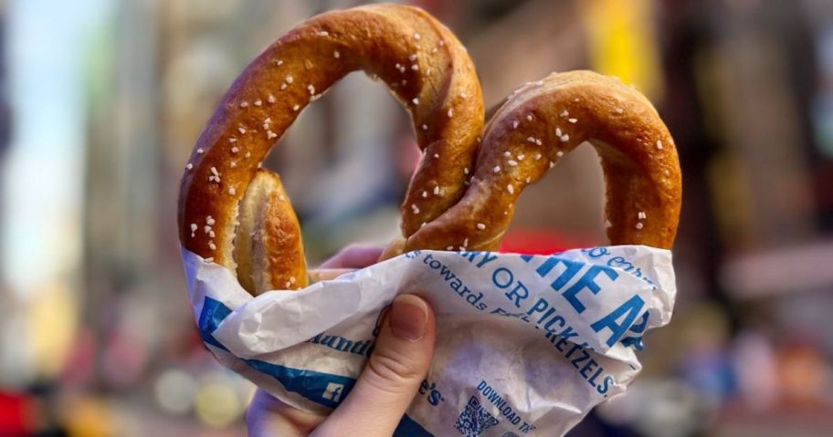 Hand holding up an Auntie Annie's Pretzel