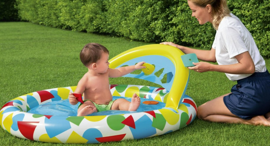 Baby playing with pool displayed