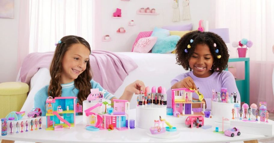 Two little girls playing with Barbieland toys