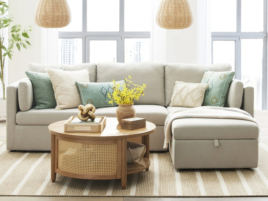 light grey sectional sofa with round coffee table