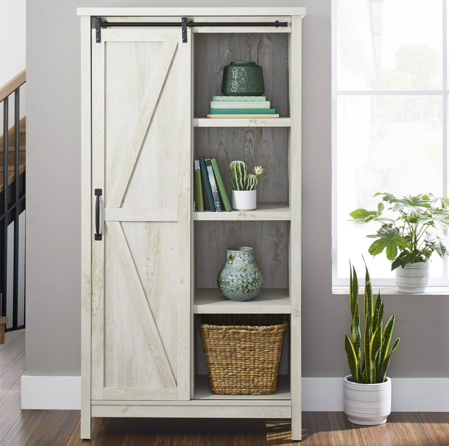 white farmhouse storage cabinet near window