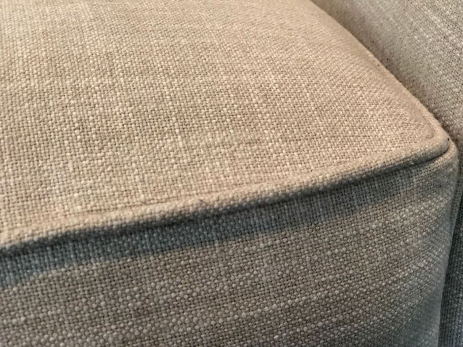 A couch cushion shown after using the fabric shaver.