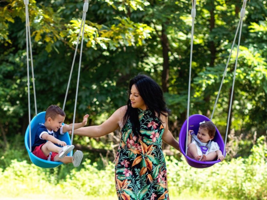 woman swinging two children in Swufer coconut swings