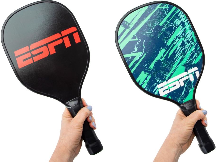 Hands holding up ESPN Pickleball Paddles